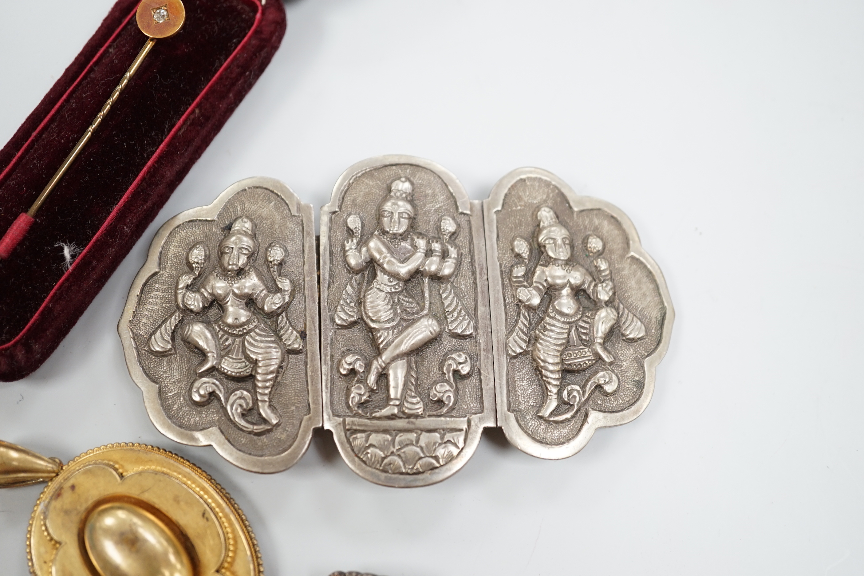 A Victorian yellow metal oval morning locket, with hair beneath a glazed panel verso, overall 56mm and four other items including a pinchbeck bangle.